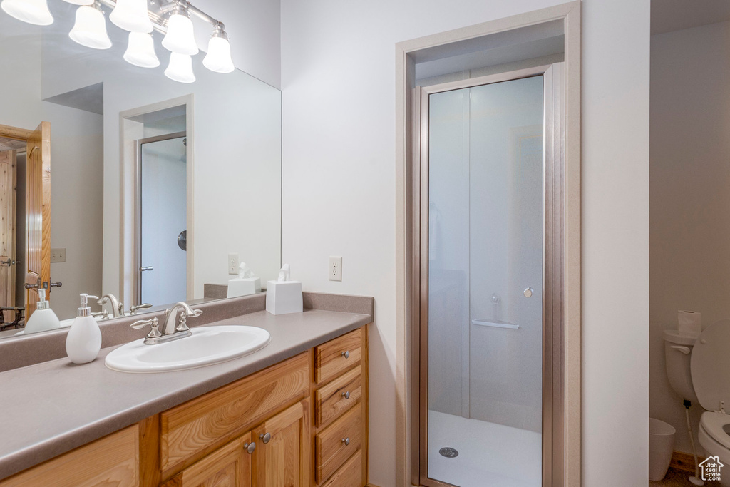 Bathroom with a stall shower and vanity