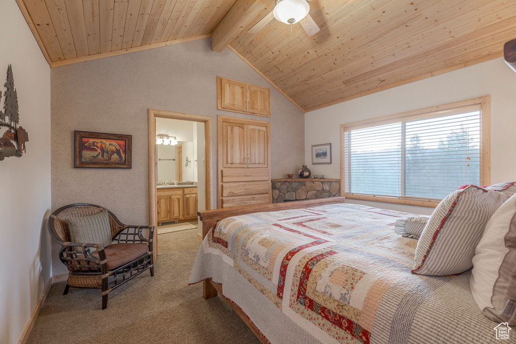 Bedroom with light carpet, ensuite bathroom, and wood ceiling
