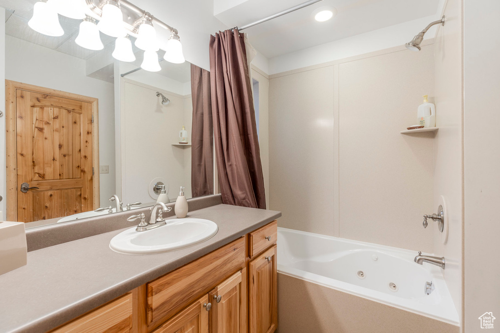 Full bathroom featuring a combined bath / shower with jetted tub and vanity