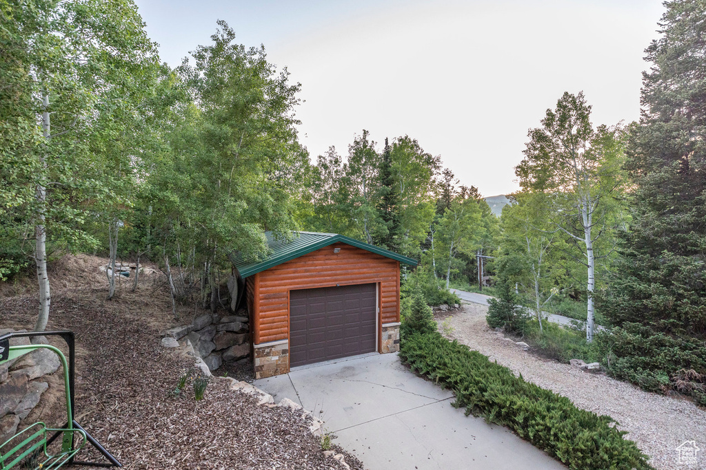 Detached garage with concrete driveway
