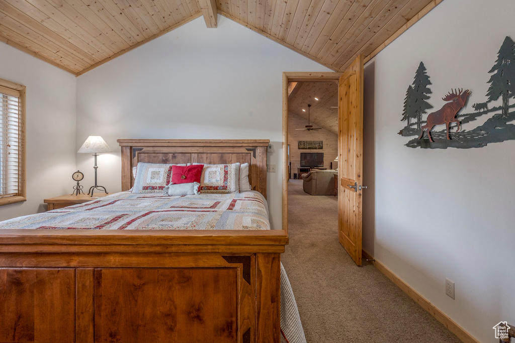 Carpeted bedroom with vaulted ceiling and wood ceiling