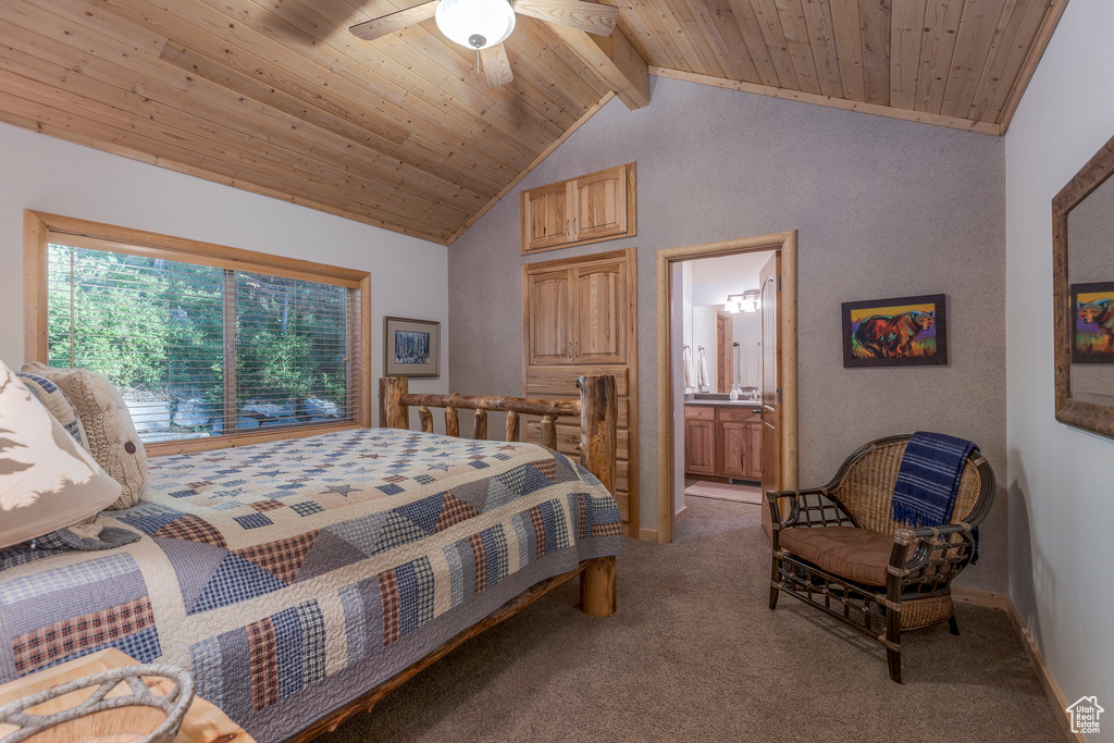 Bedroom with carpet, wood ceiling, ensuite bathroom, and ceiling fan