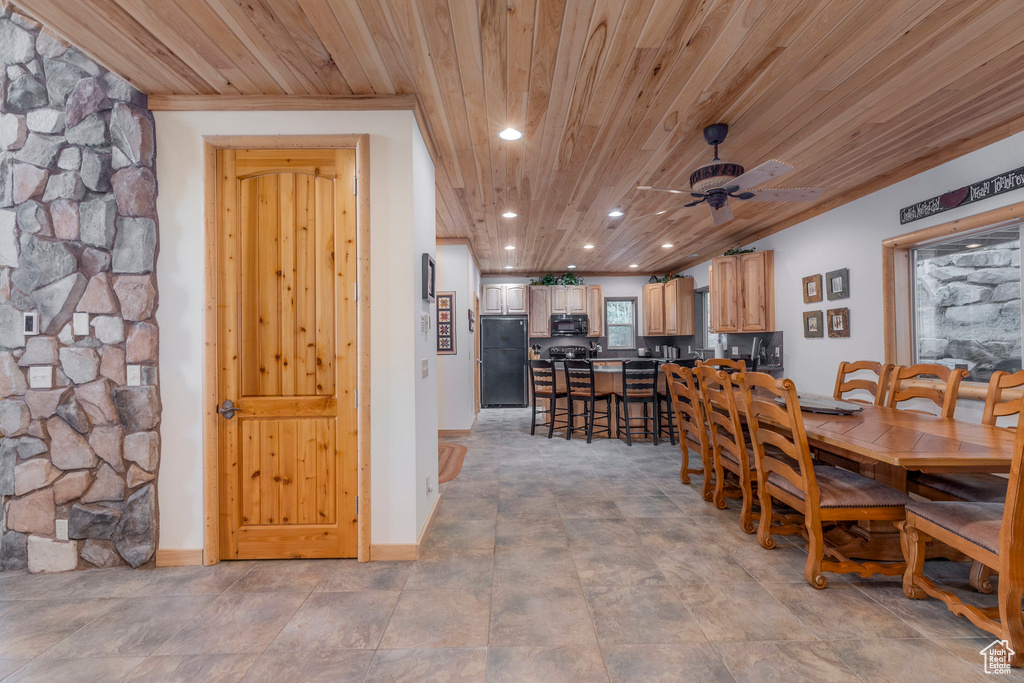 Dining space featuring wooden ceiling, ceiling fan, recessed lighting, and crown molding