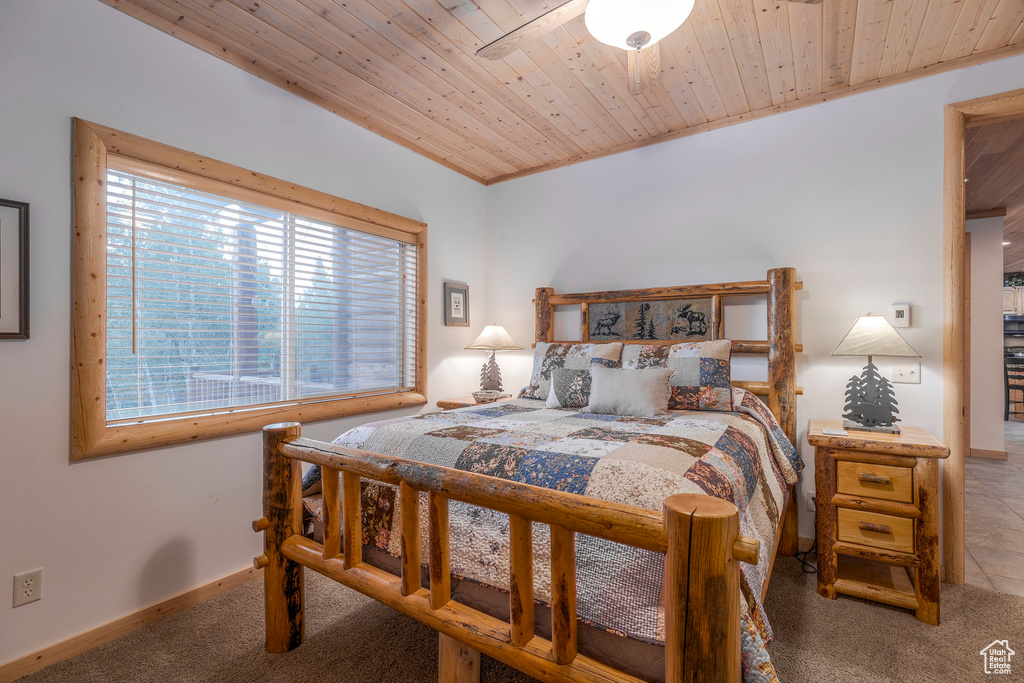 Carpeted bedroom with wood ceiling
