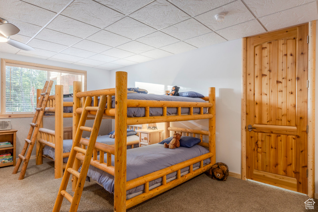Bedroom featuring a drop ceiling and carpet