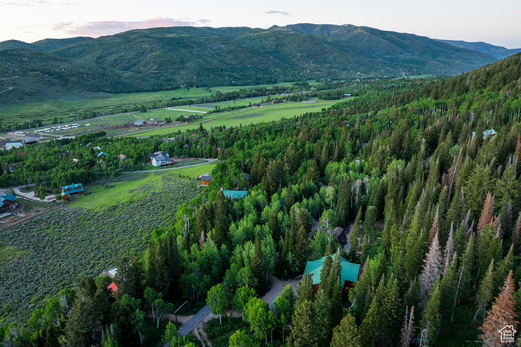 Aerial view of property\'s location featuring a mountainous background and rural landscape
