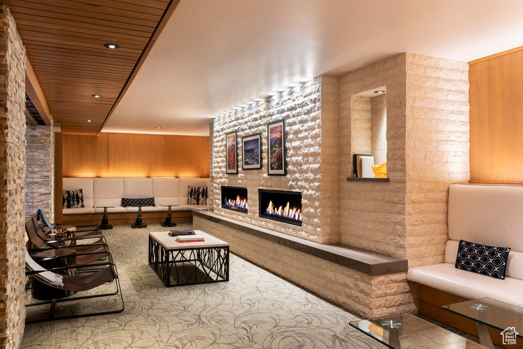 Living room with a tiled fireplace and wooden ceiling