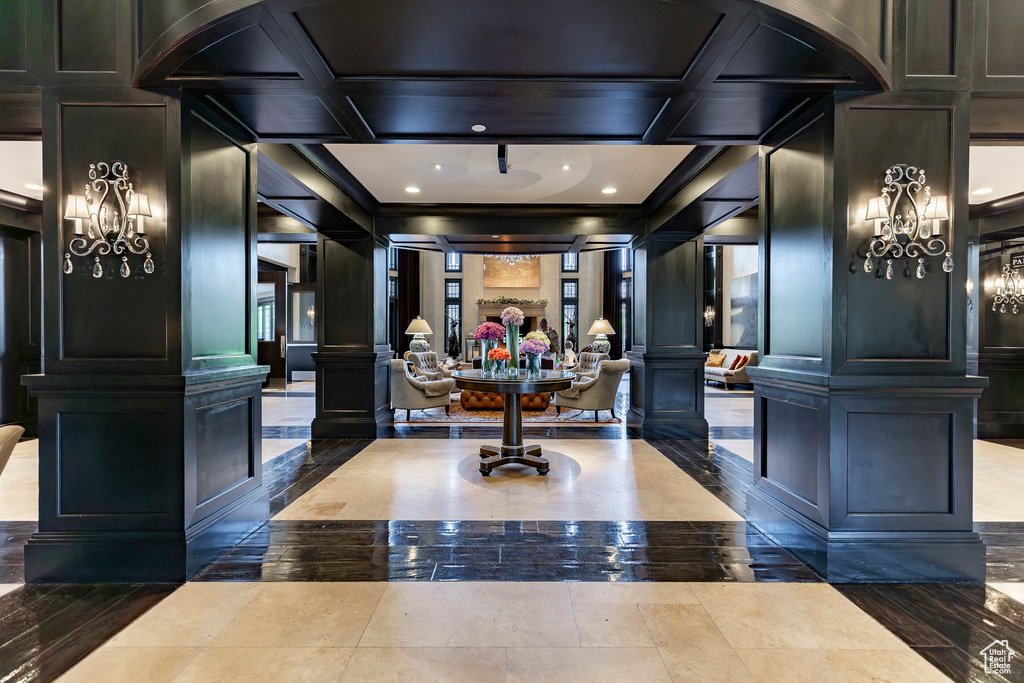 Welcome area featuring a decorative wall, decorative columns, crown molding, recessed lighting, and arched walkways