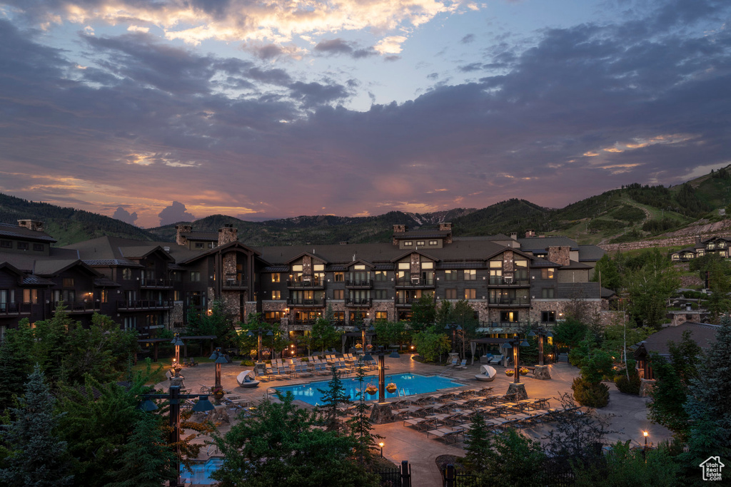 Community pool featuring a mountain view and a patio area