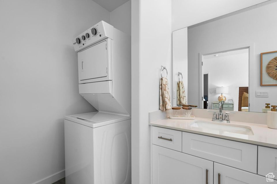 Laundry area featuring stacked washing machine and dryer