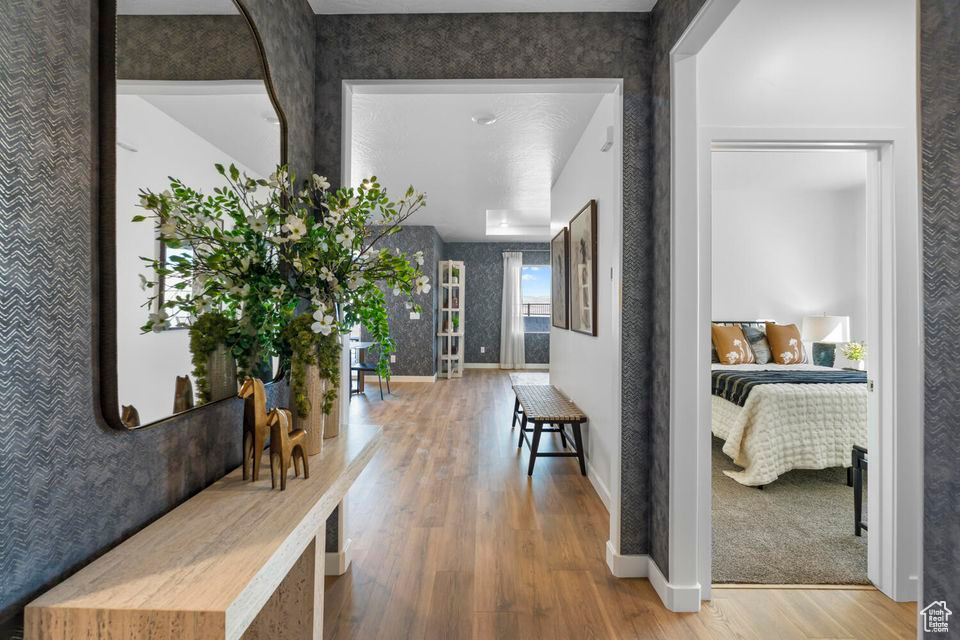 Corridor featuring wood finished floors and baseboards