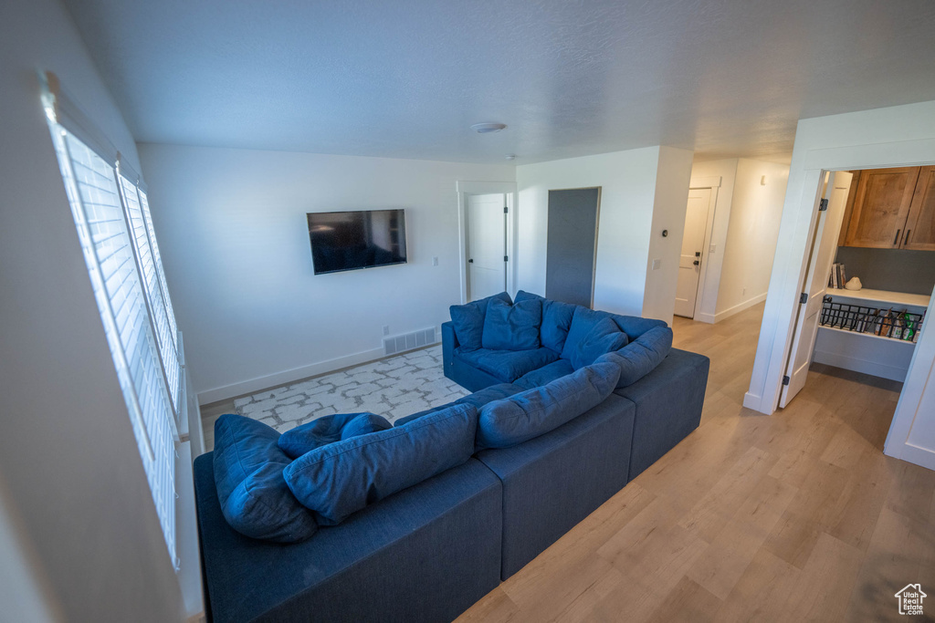 Living area featuring baseboards and light wood-style flooring