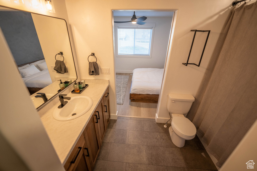 Full bathroom featuring ensuite bathroom, vanity, tile patterned flooring, and ceiling fan