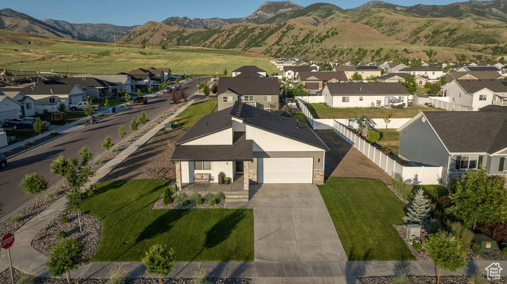 Aerial view of residential area featuring a mountainous background