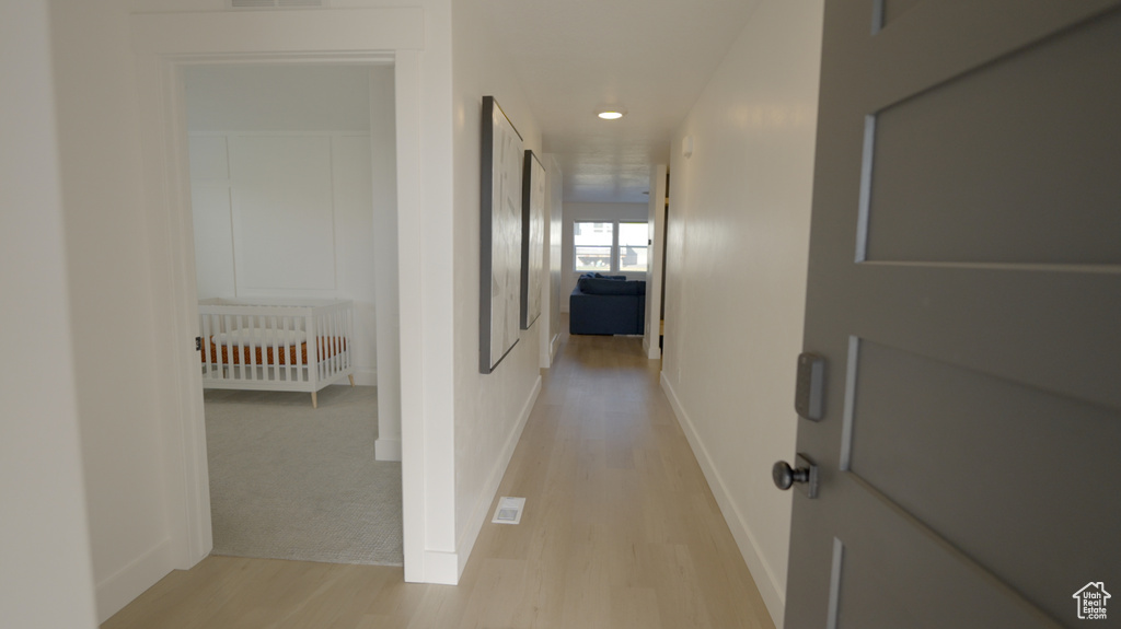Hall featuring light wood-style floors and recessed lighting