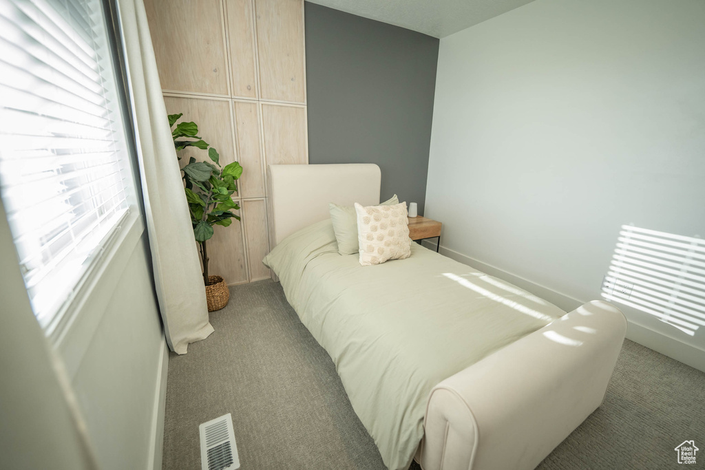 Carpeted bedroom featuring baseboards