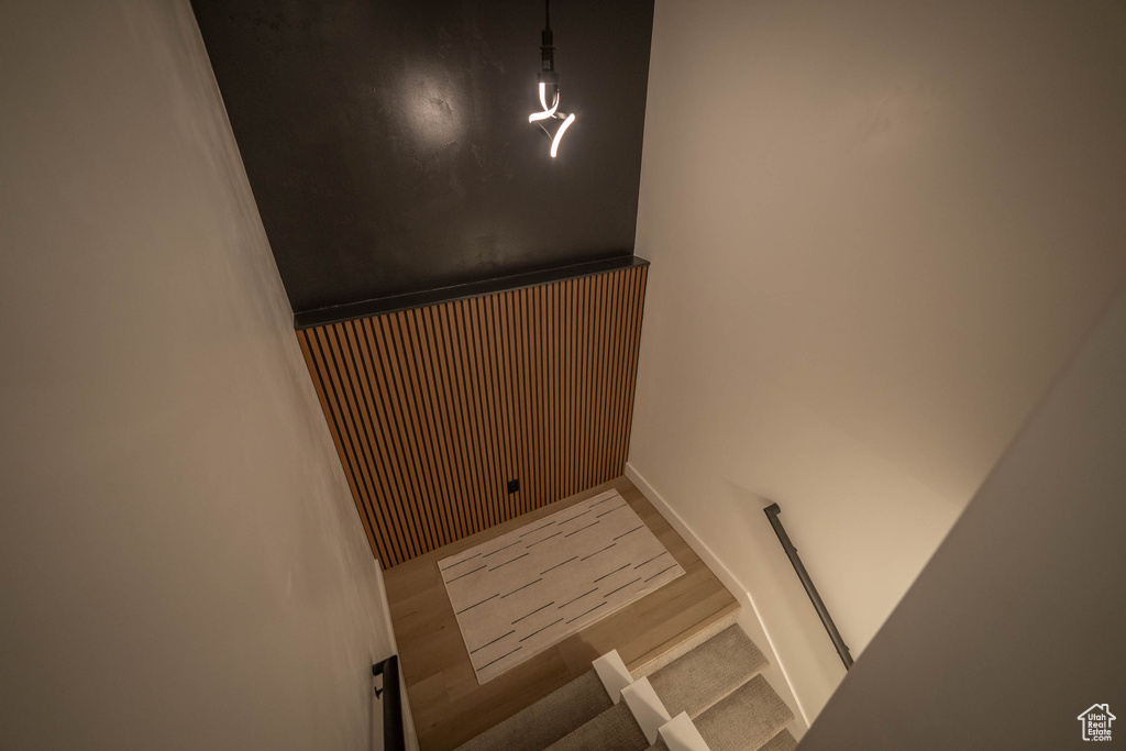 Stairs with wood finished floors and baseboards