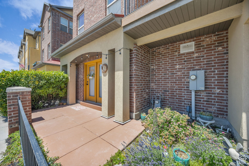 Property entrance featuring brick siding and stucco siding