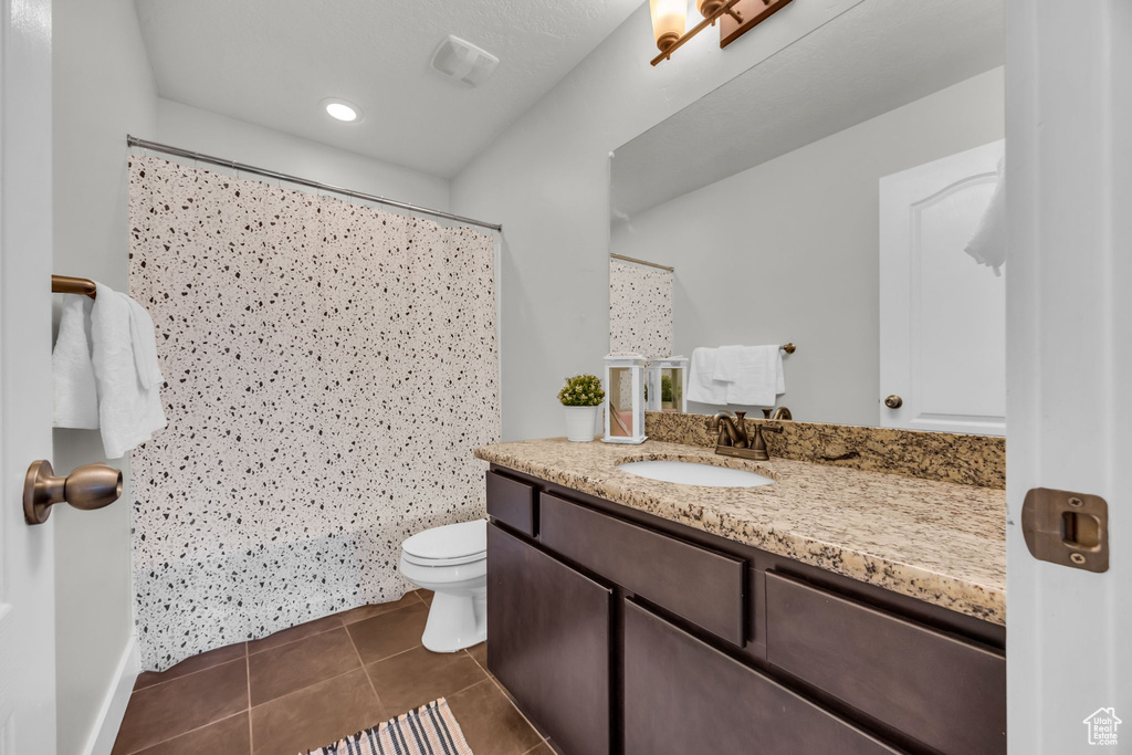 Full bath featuring vanity, tile patterned flooring, and curtained shower