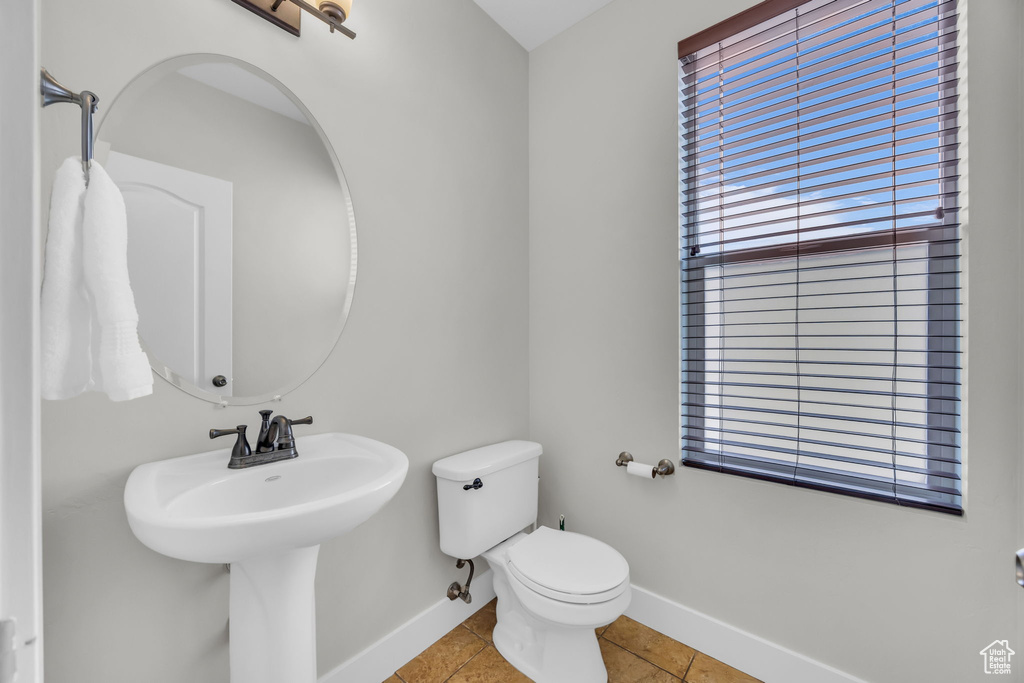 Bathroom with healthy amount of natural light and tile patterned flooring