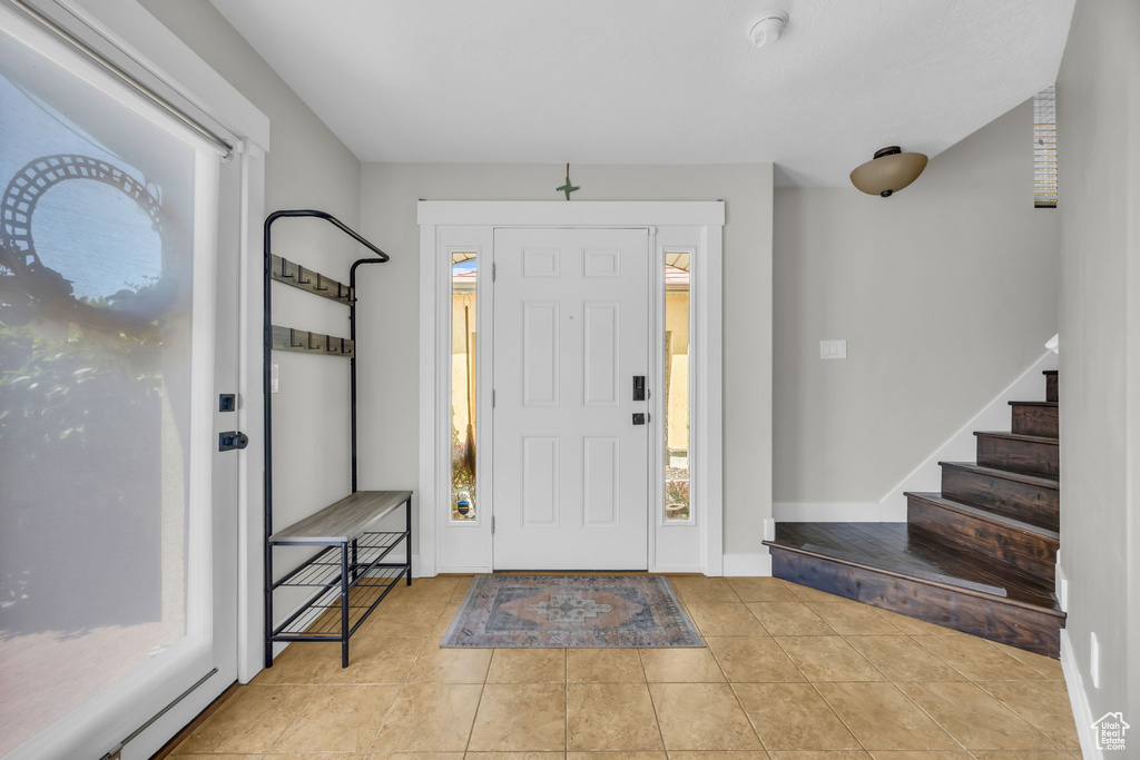 Foyer with stairway and tile patterned flooring