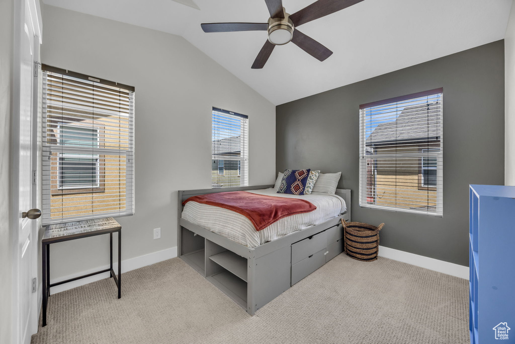Bedroom with lofted ceiling, carpet, and a ceiling fan