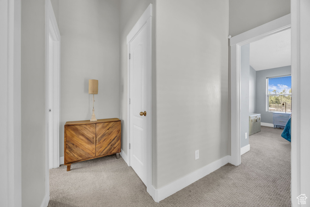 Corridor featuring carpet flooring