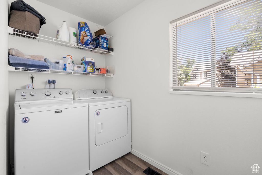 Washroom with separate washer and dryer and dark wood-style flooring