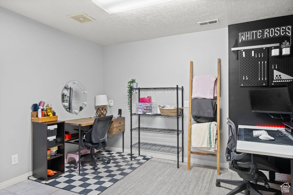 Home office with baseboards and a textured ceiling