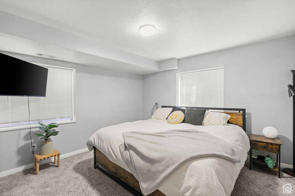 Bedroom featuring carpet flooring and baseboards
