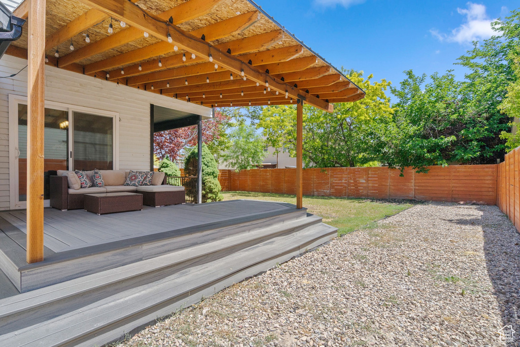 Wooden deck with a fenced backyard and an outdoor hangout area