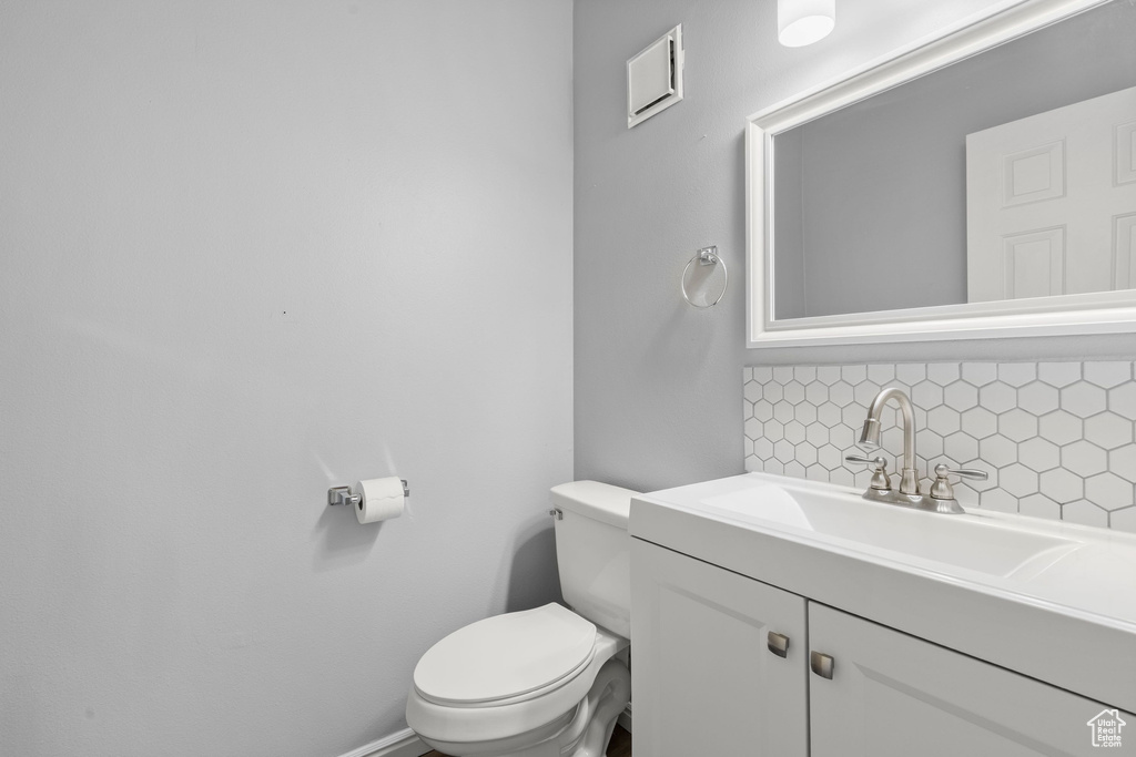 Bathroom with decorative backsplash and vanity