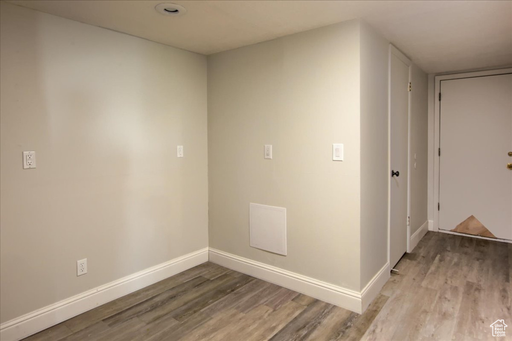 Spare room featuring light wood-style floors and baseboards