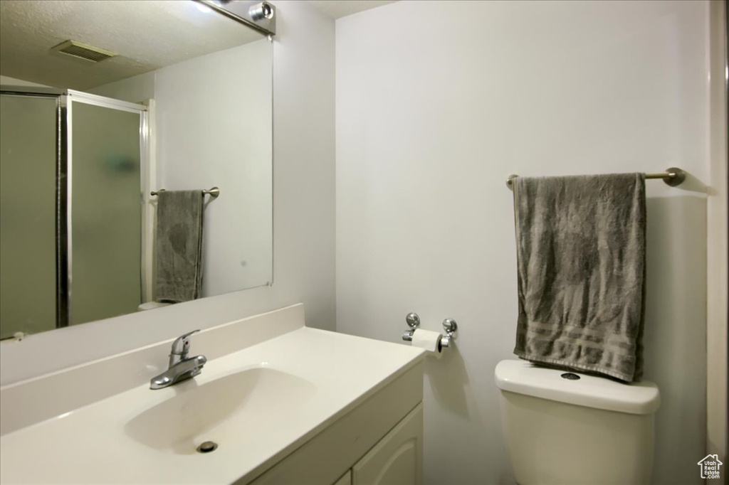 Full bathroom featuring vanity and a shower stall