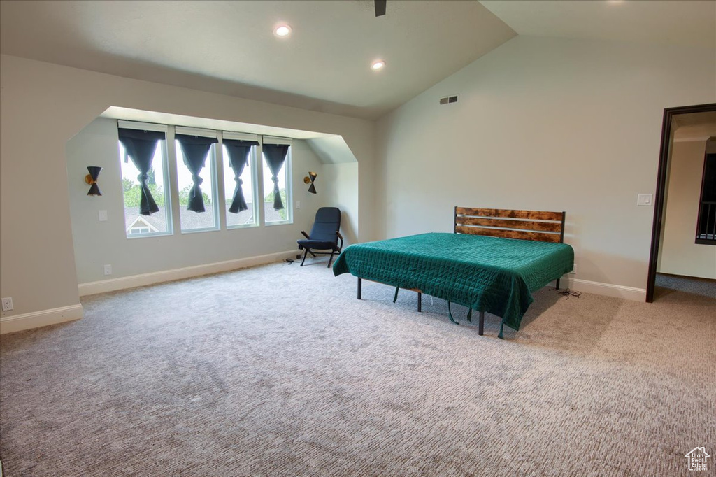 Carpeted bedroom featuring recessed lighting and high vaulted ceiling