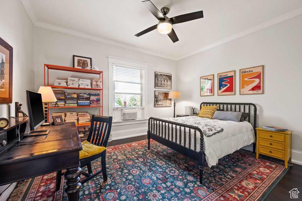 Bedroom with wood finished floors, ornamental molding, a desk, and a ceiling fan