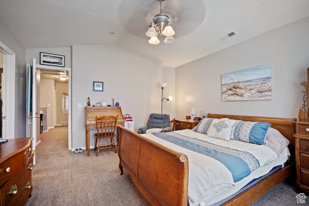 Bedroom featuring carpet floors, lofted ceiling, and a ceiling fan
