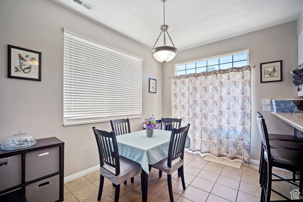 Dining room with light tile patterned floors and baseboards