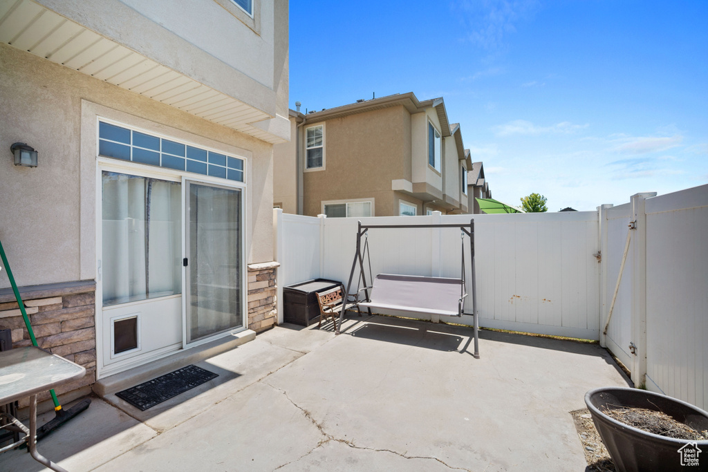Fenced backyard with a patio area and a gate