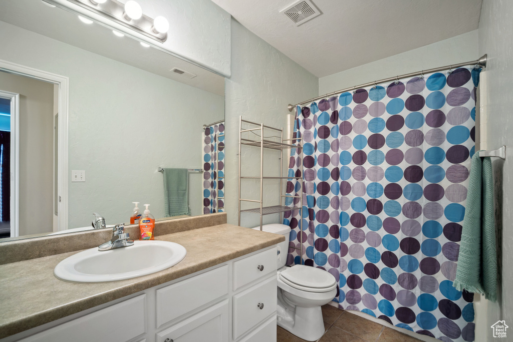 Full bath featuring vanity, tile patterned floors, and curtained shower