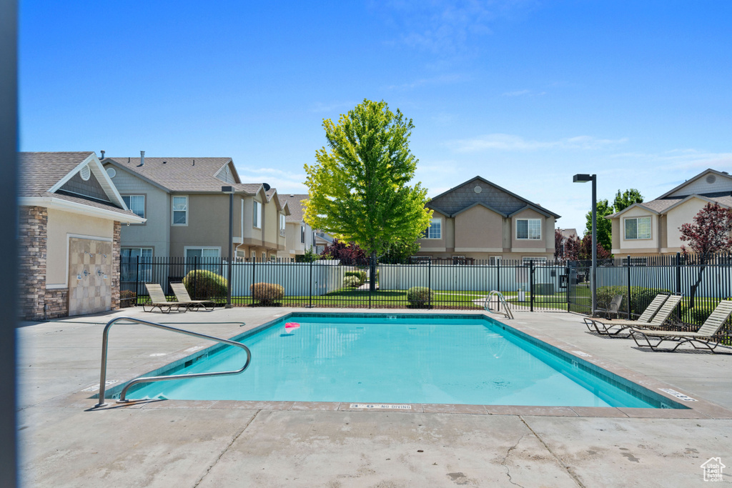 Community pool featuring a residential view and a patio