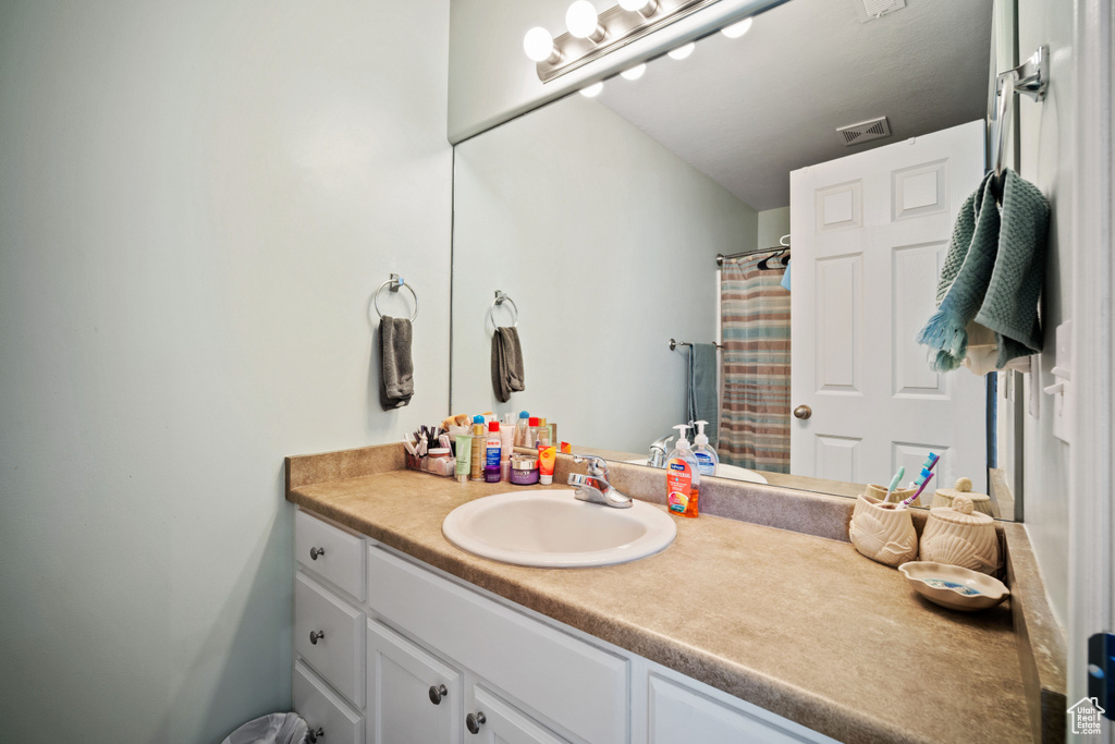 Bathroom with vanity and a shower with curtain