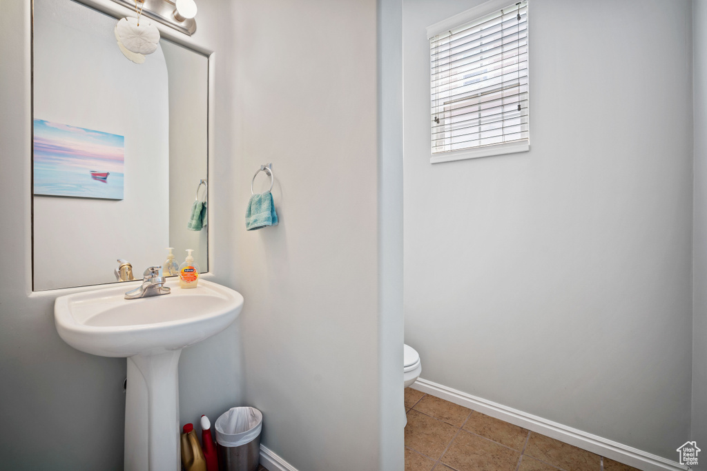 Half bath featuring baseboards and tile patterned floors