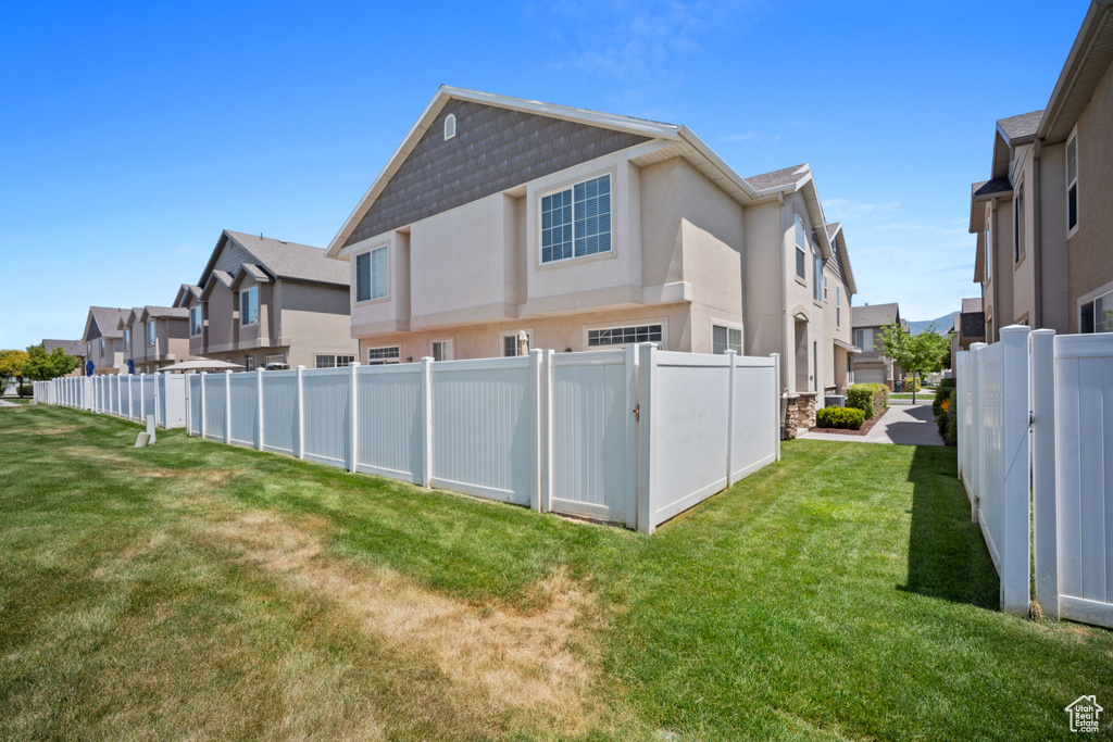 Rear view of property with a residential view and stucco siding