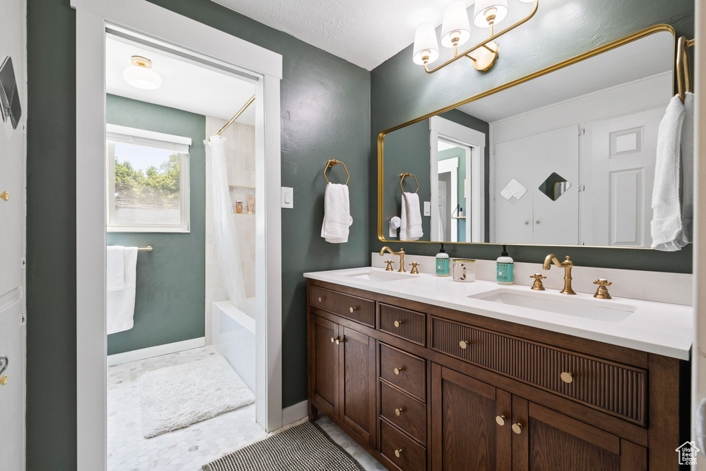 Full bath with double vanity and shower / bath combo with shower curtain