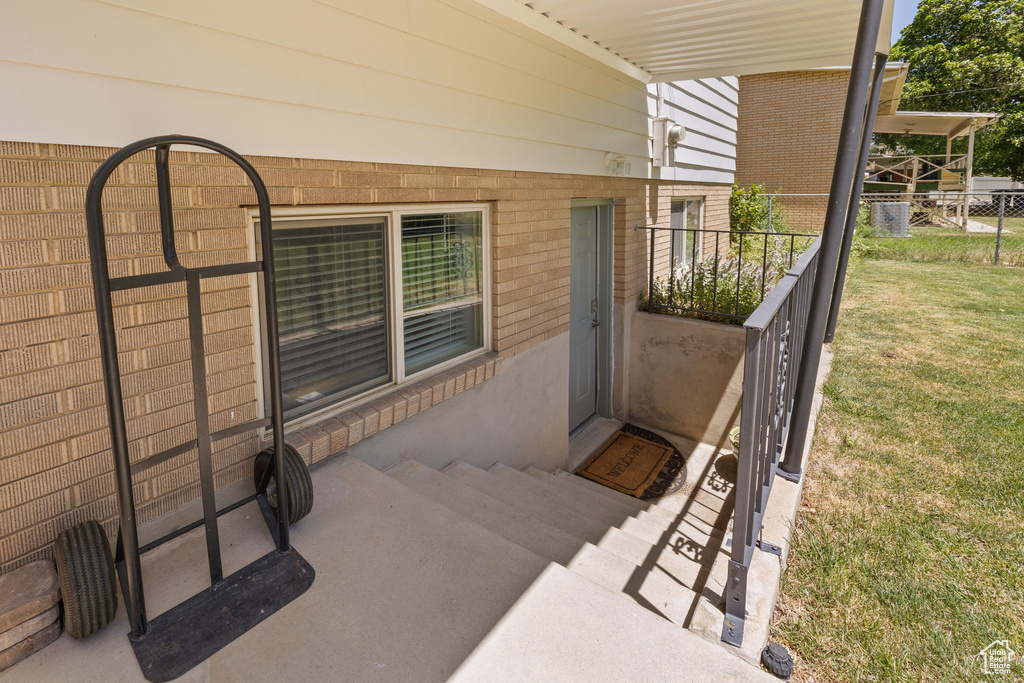 View of exterior entry featuring brick siding
