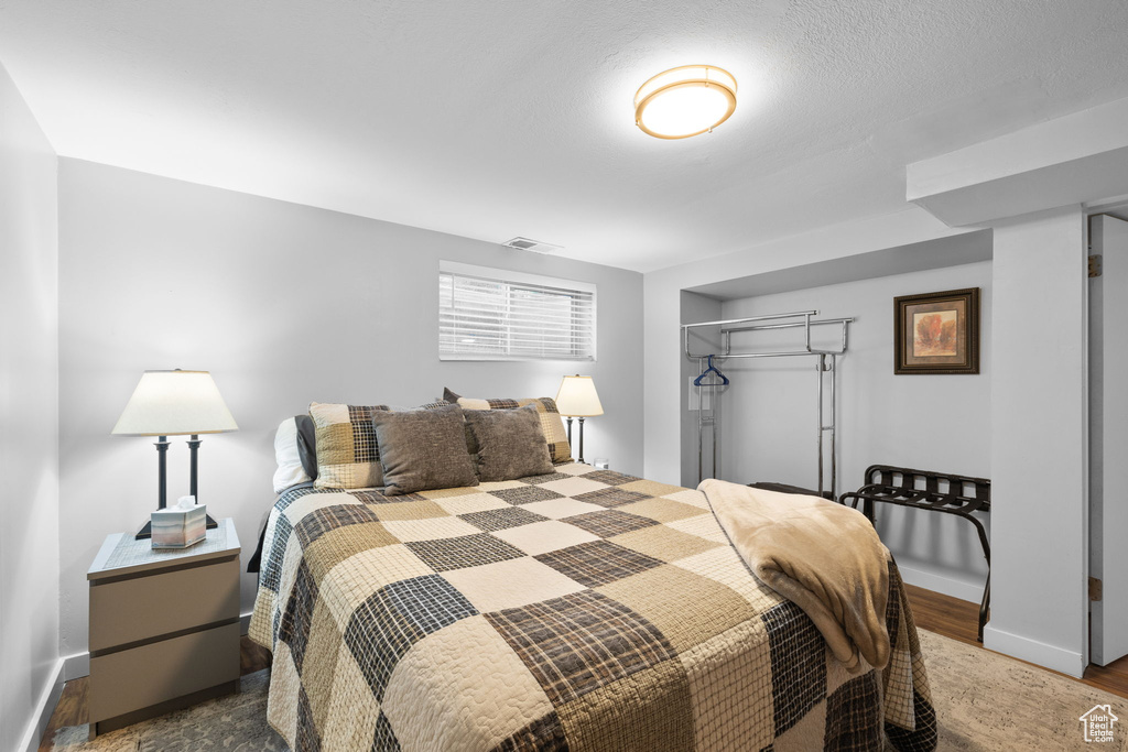 Bedroom with a closet and wood finished floors