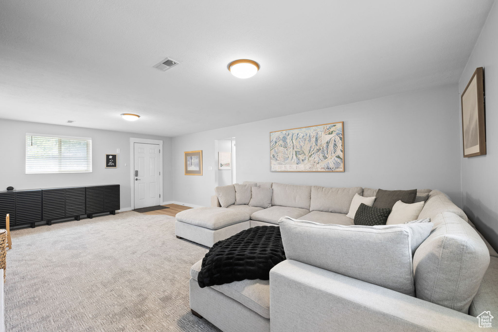 Carpeted living area featuring baseboards