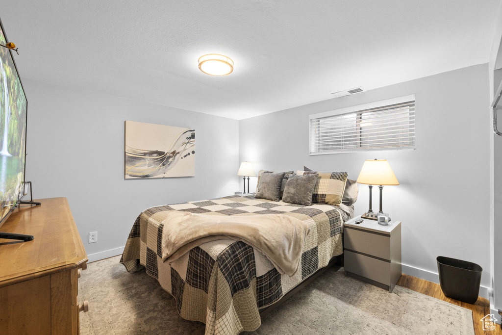 Bedroom featuring baseboards and wood finished floors