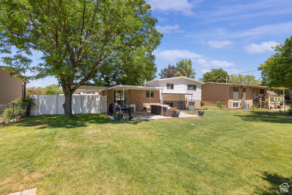 Back of property featuring brick siding, outdoor lounge area, and a patio area